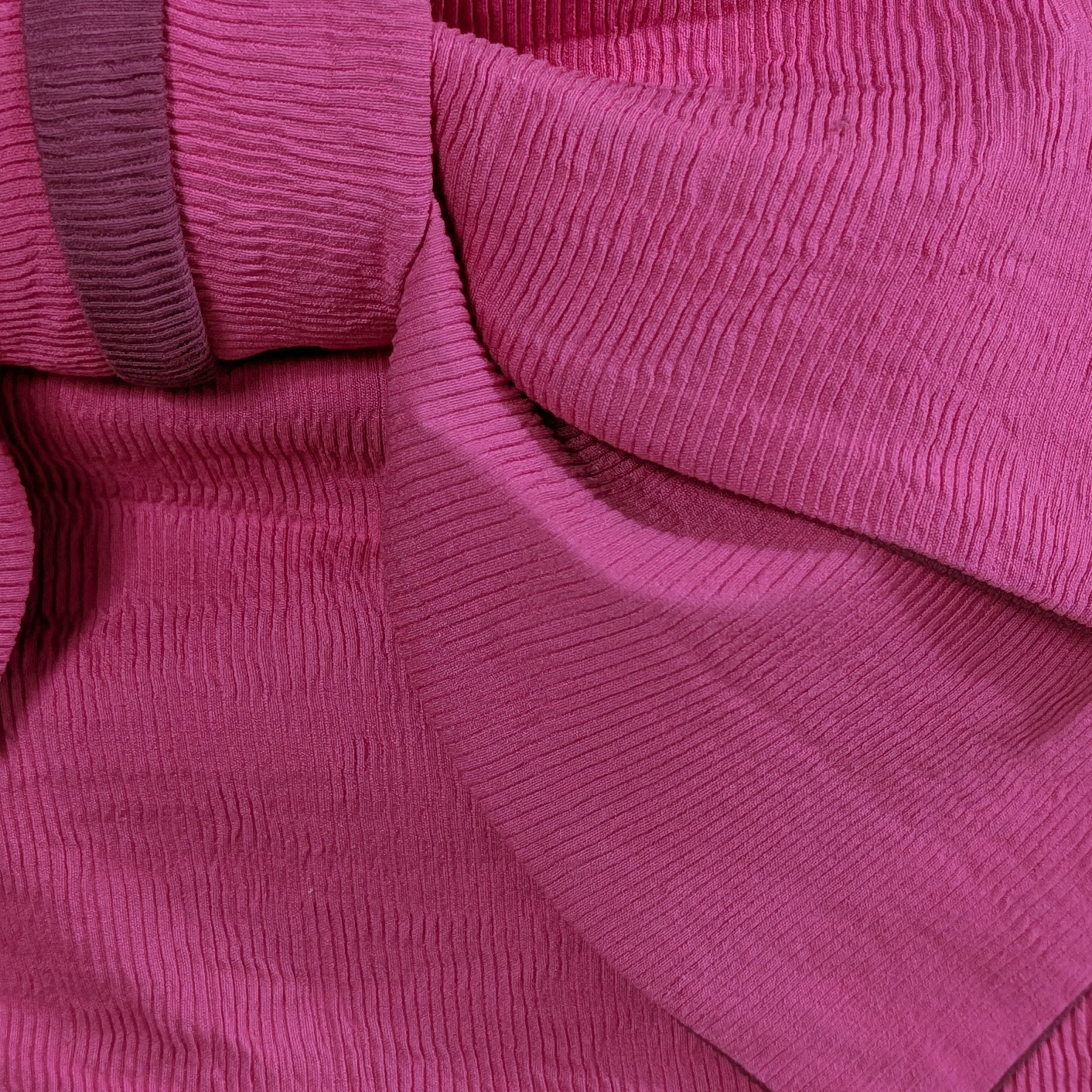Close-up of a pink ribbed fabric texture
