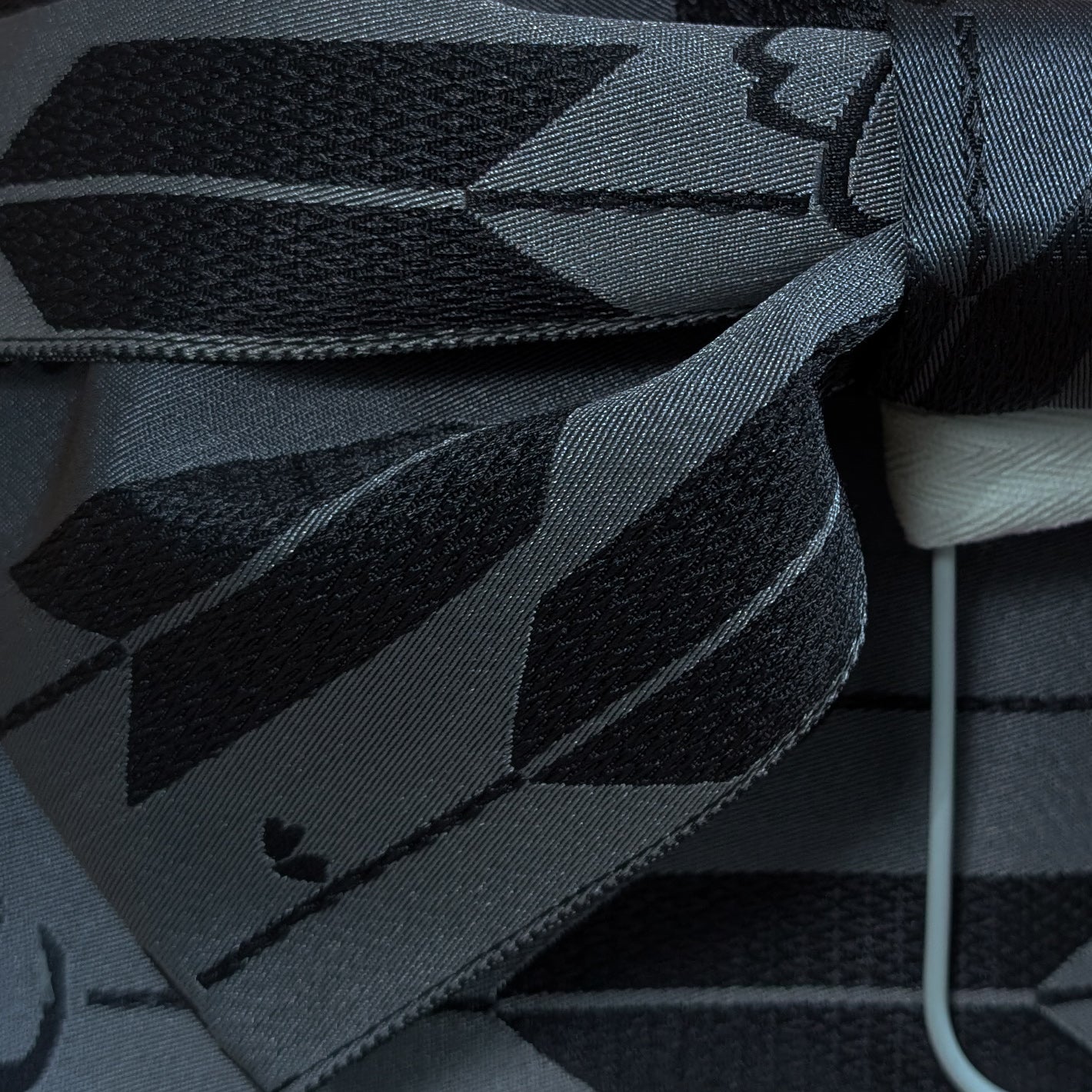 Close-up of a gray and black patterned fabric of a Japanese waist belt