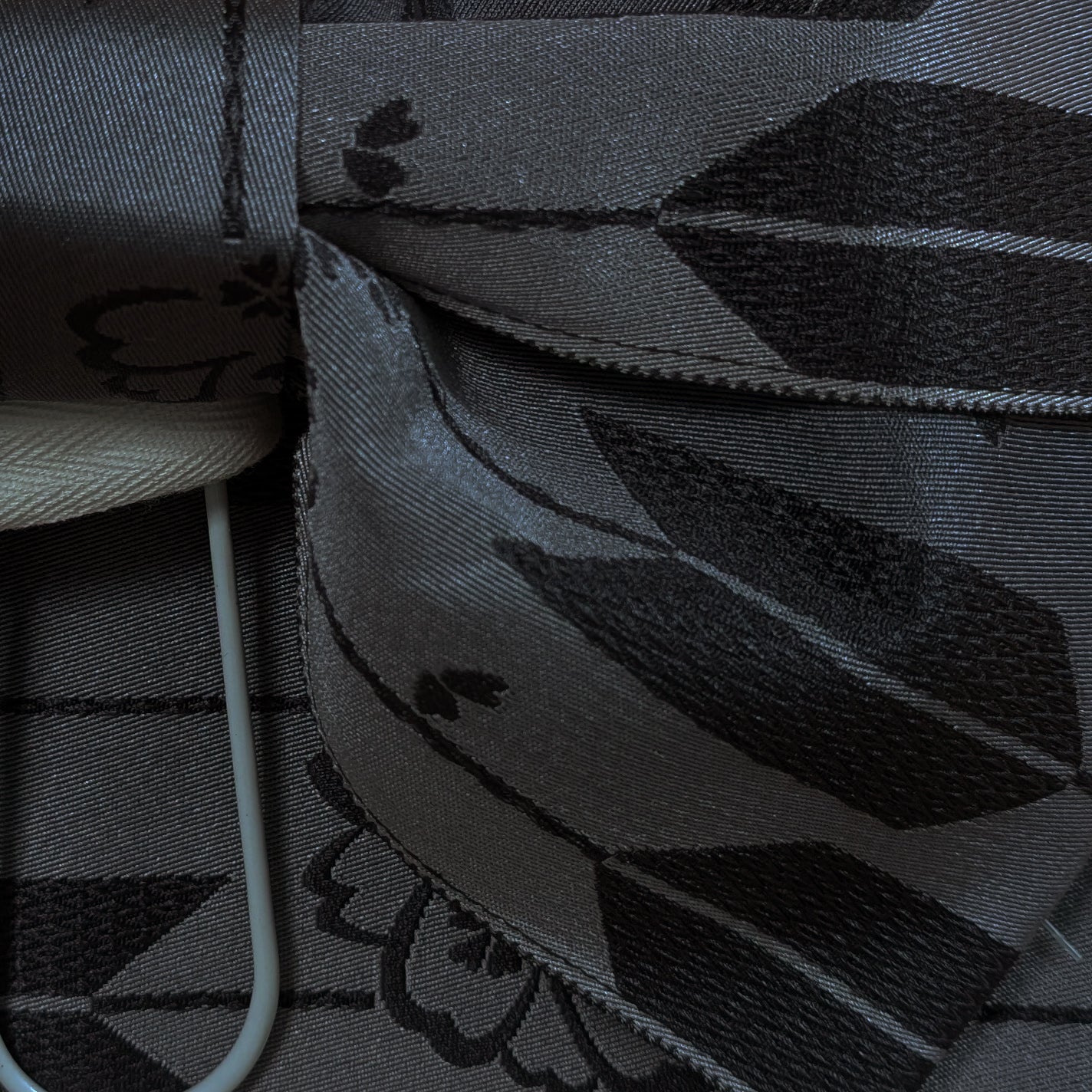 Close-up of a textured black fabric with geometric patterns from a traditional Japanese obi