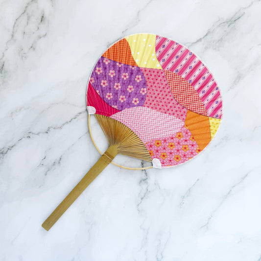 Colorful patchwork fan on a marble surface
