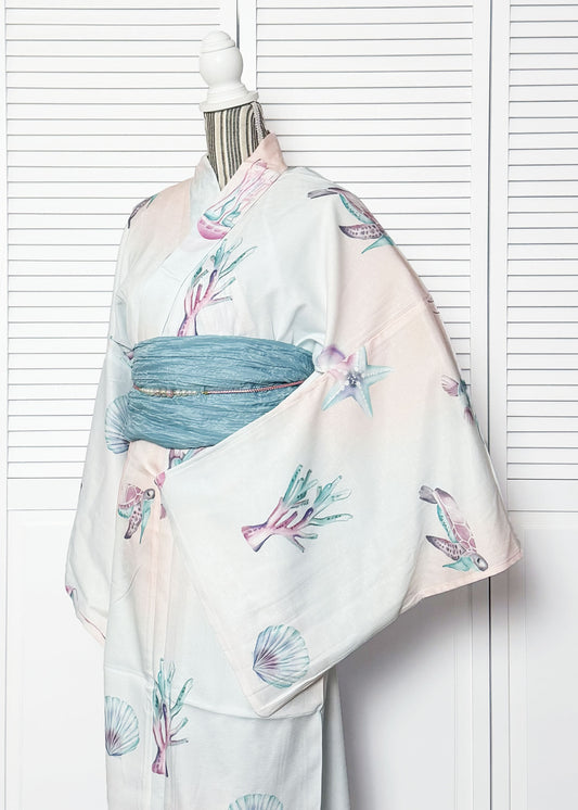 Mannequin wearing a traditional Japanese kimono with floral patterns against a white background
