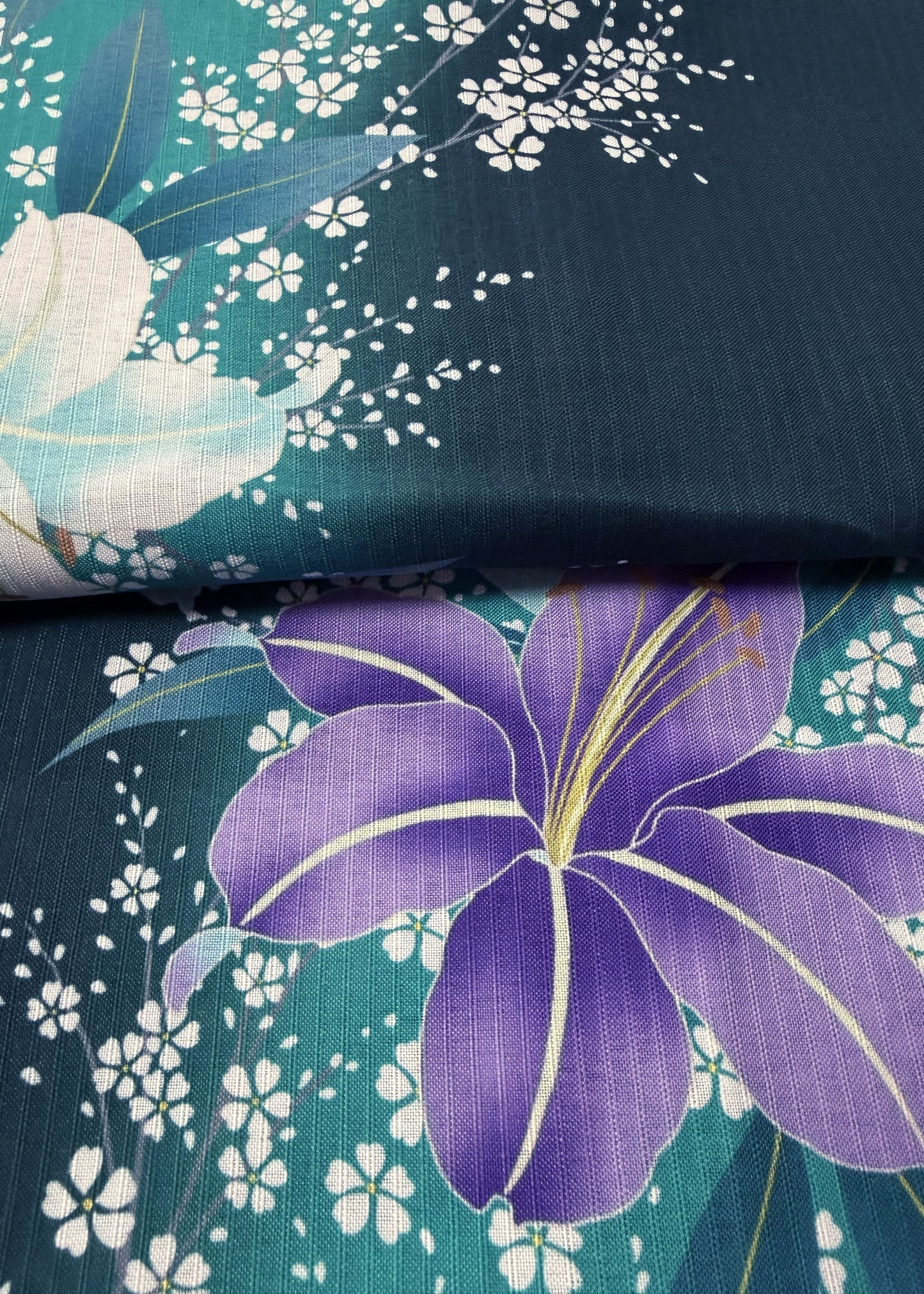 Floral fabric with purple flower and white flowers on a teal background