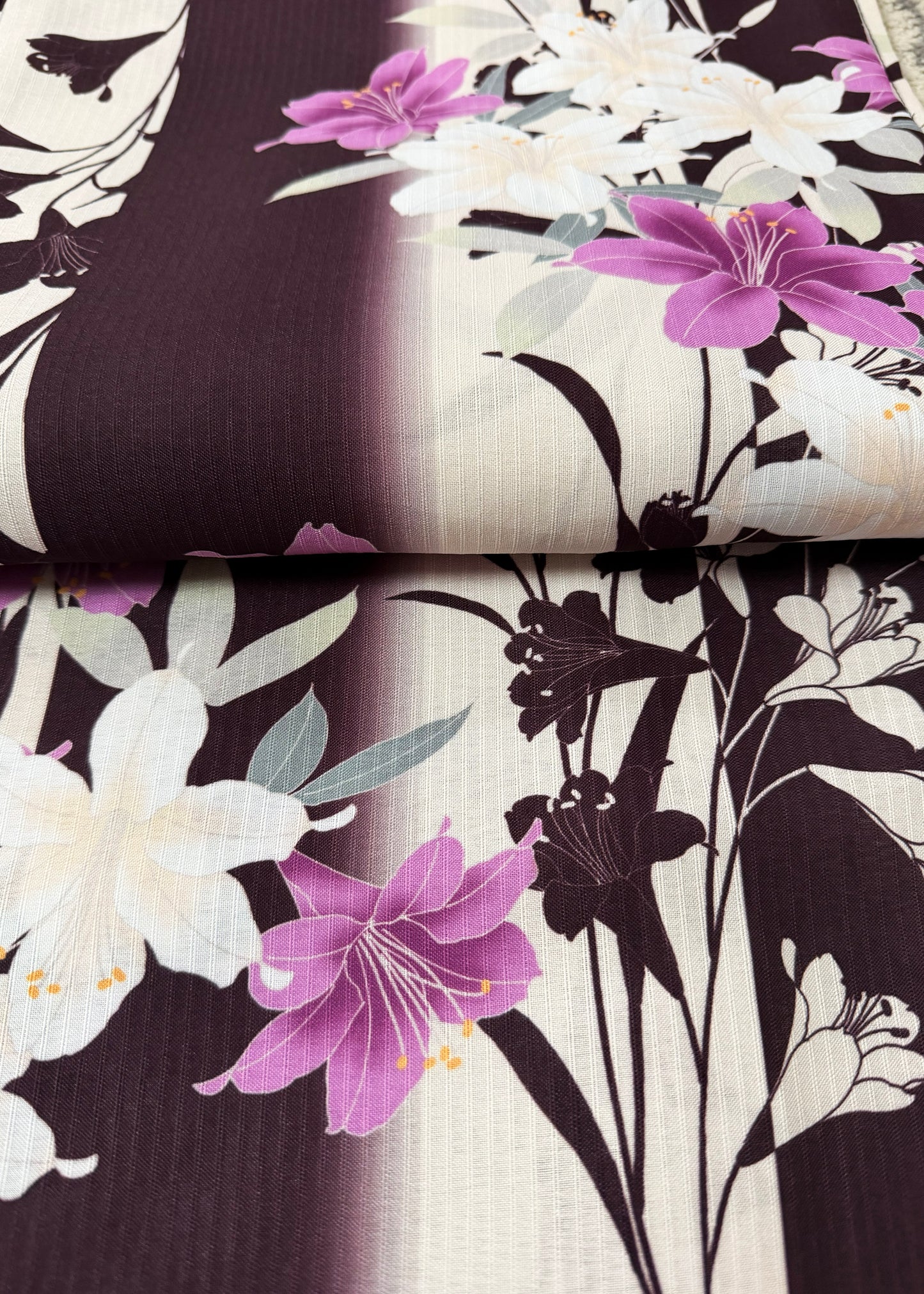 Floral fabric swatches with purple and white flowers on a dark background