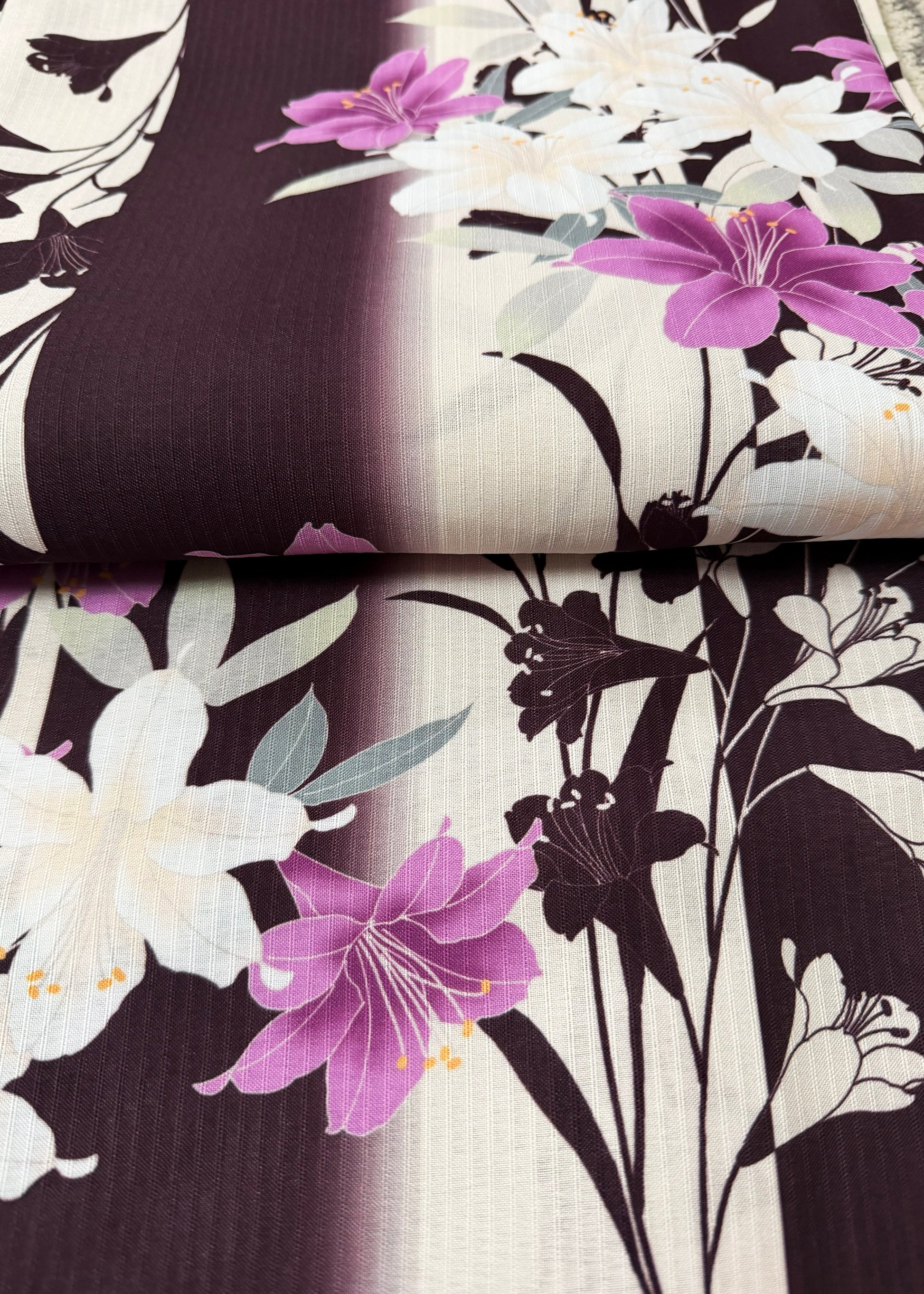 Floral fabric swatches with purple and white flowers on a dark background