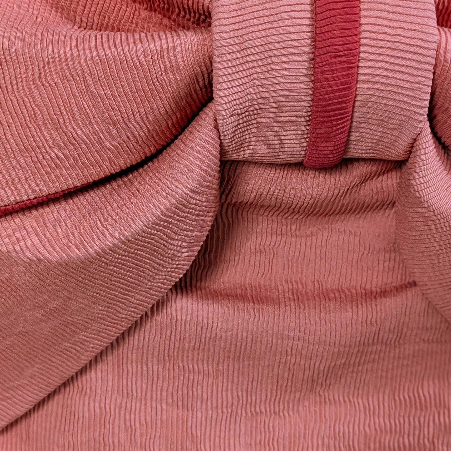 Close-up of pink ribbed fabric from a Japanese waist belt