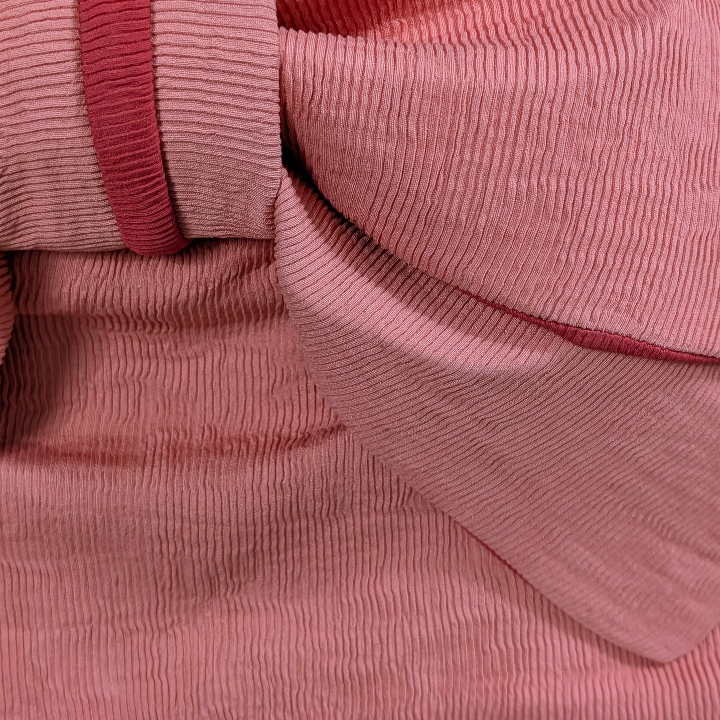 Close-up of pink ribbed fabric texture from a Japanese women's obi belt