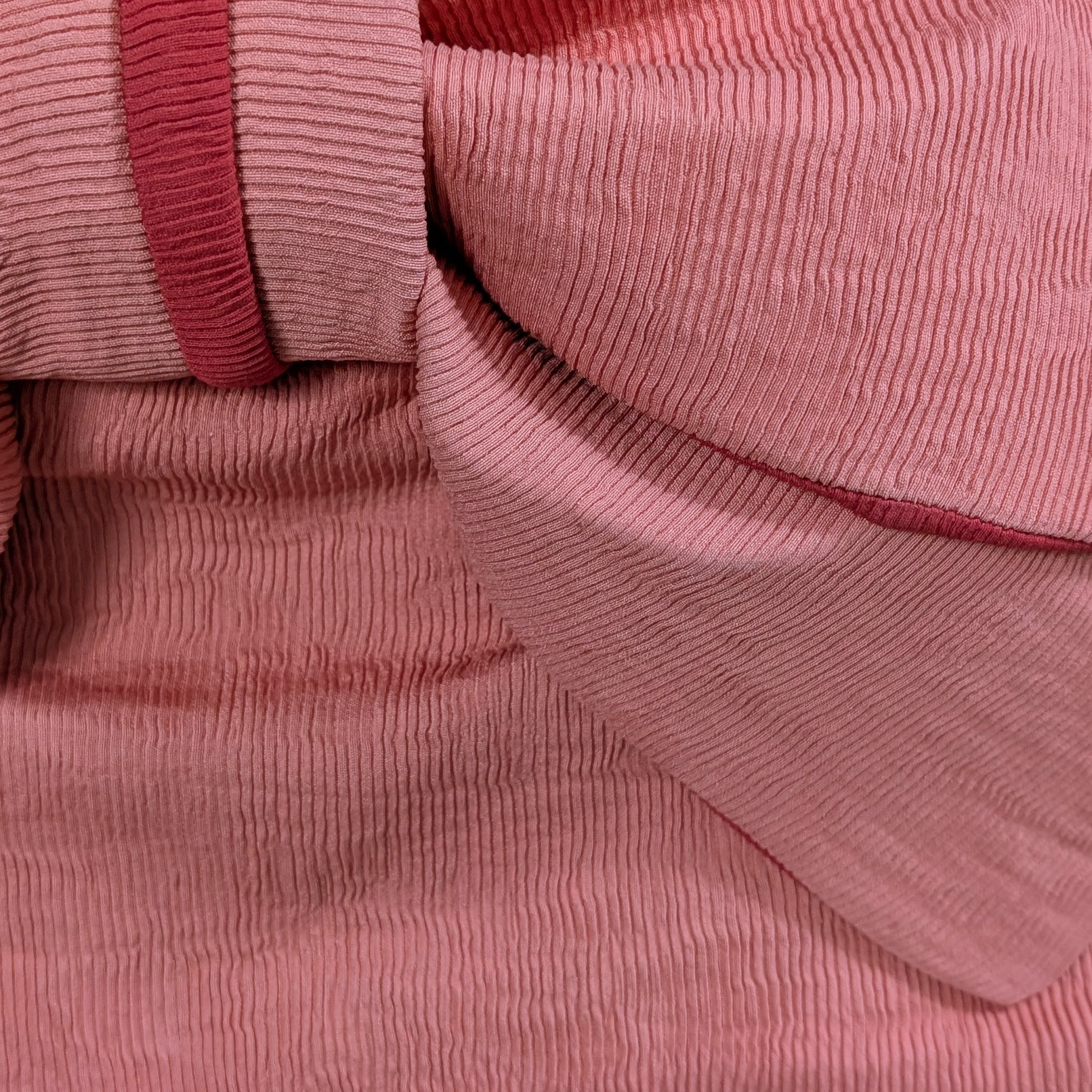 Close-up of pink ribbed fabric texture from a Japanese women's obi belt