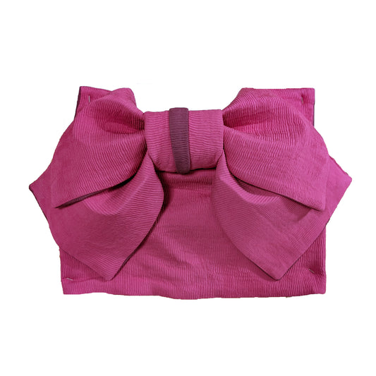 Pink fabric with a large bow 