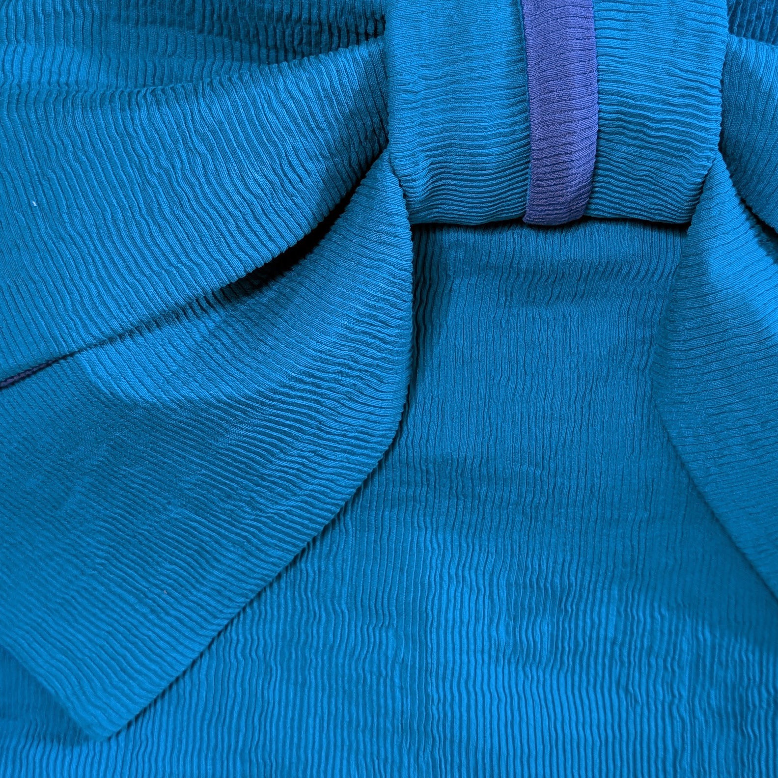 Close-up of blue fabric with a purple strap from a Japanese obi belt