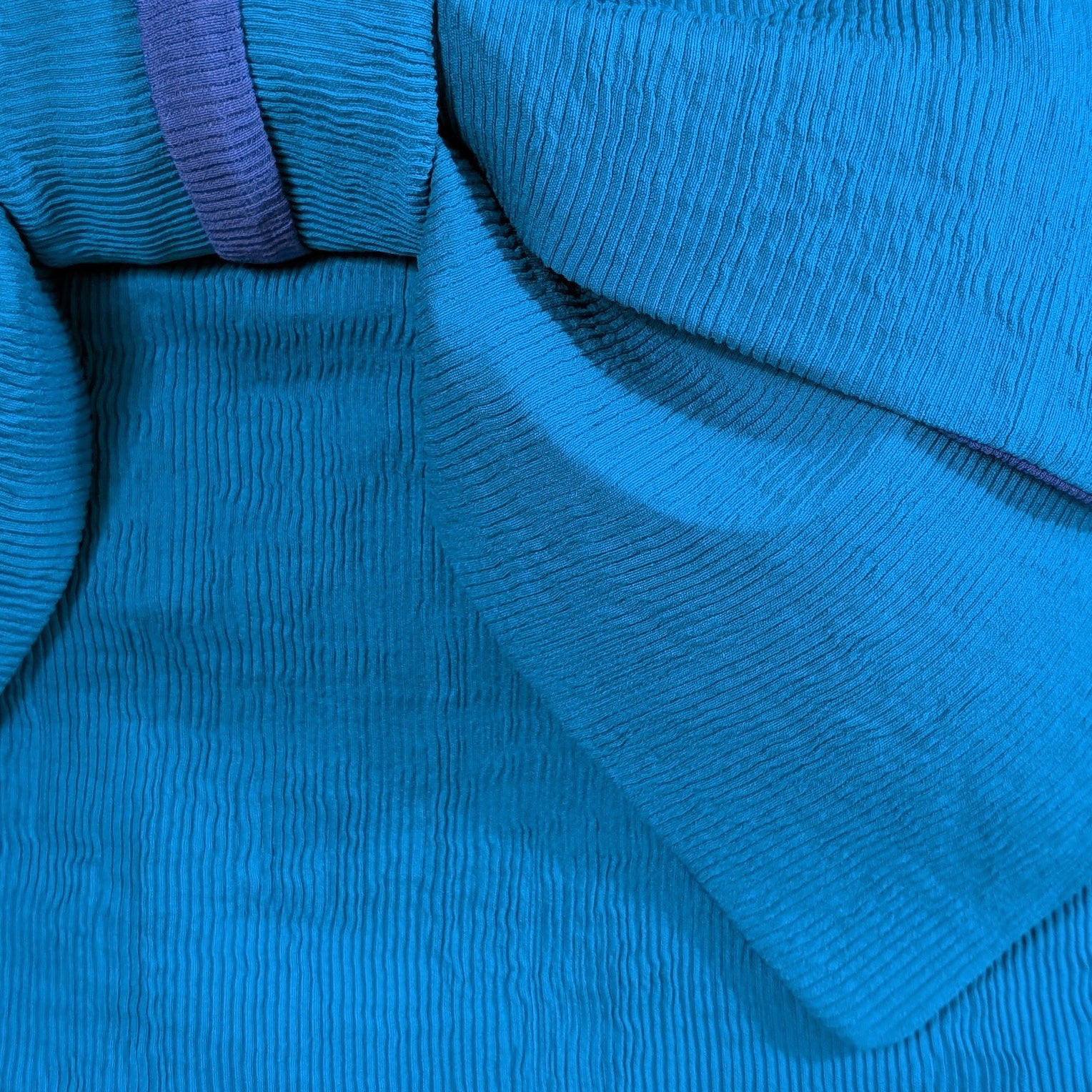 Close-up of blue fabric with a textured pattern from  a Japanese obi belt