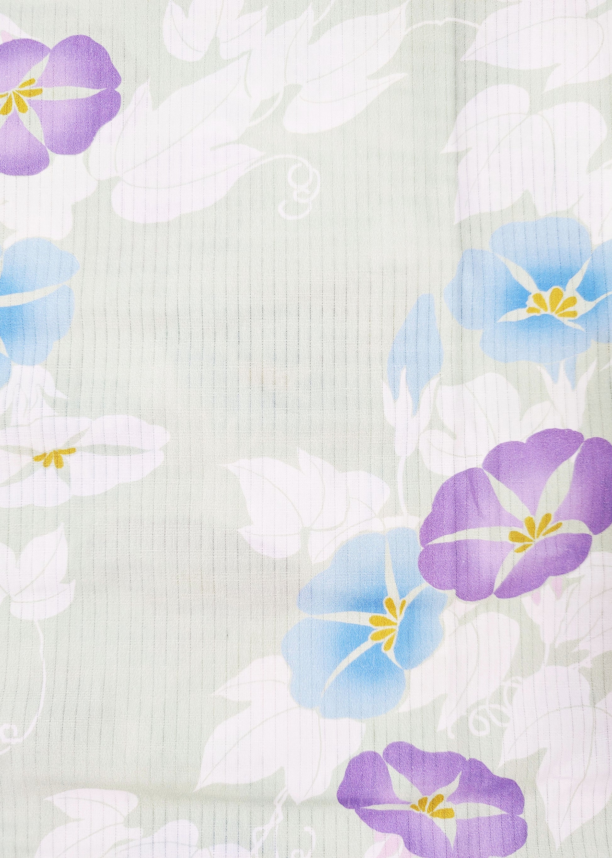 Floral pattern with purple and blue flowers on a textured white background
