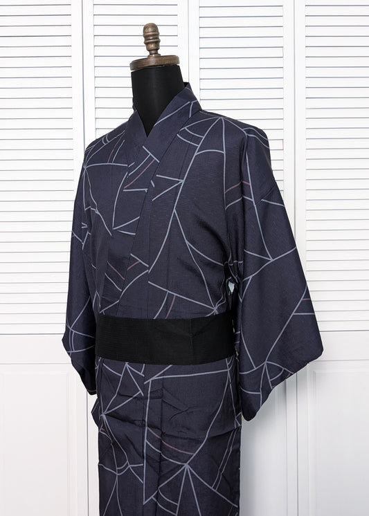 Navy blue kimono with white abstract patterns on a mannequin against a white background