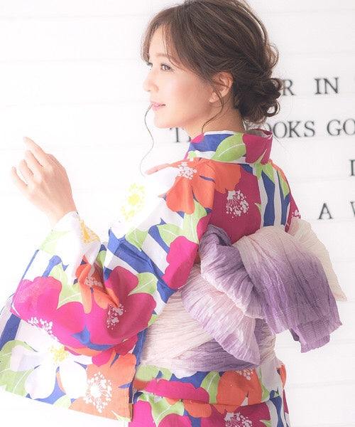 Woman wearing floral yukata and purple pink soft obi belt